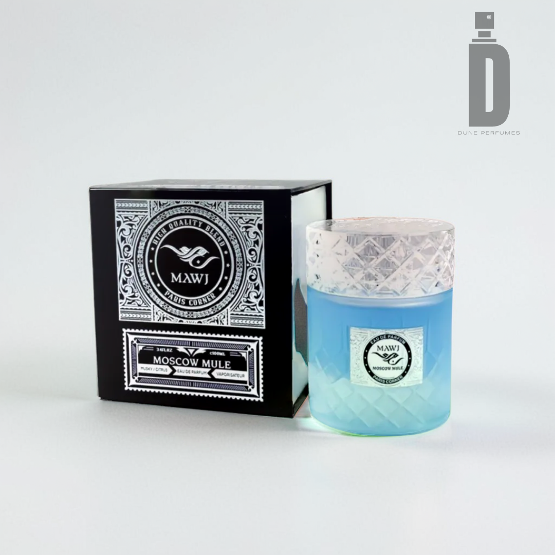 A glass container filled with blue liquid is positioned next to an ornate black and white box labeled "Moscow Mule 100ml EDP - Paris Corner." The box displays intricate patterns and logos, emitting a refreshing fragrance. A "Paris Corner" logo is visible in the corner.