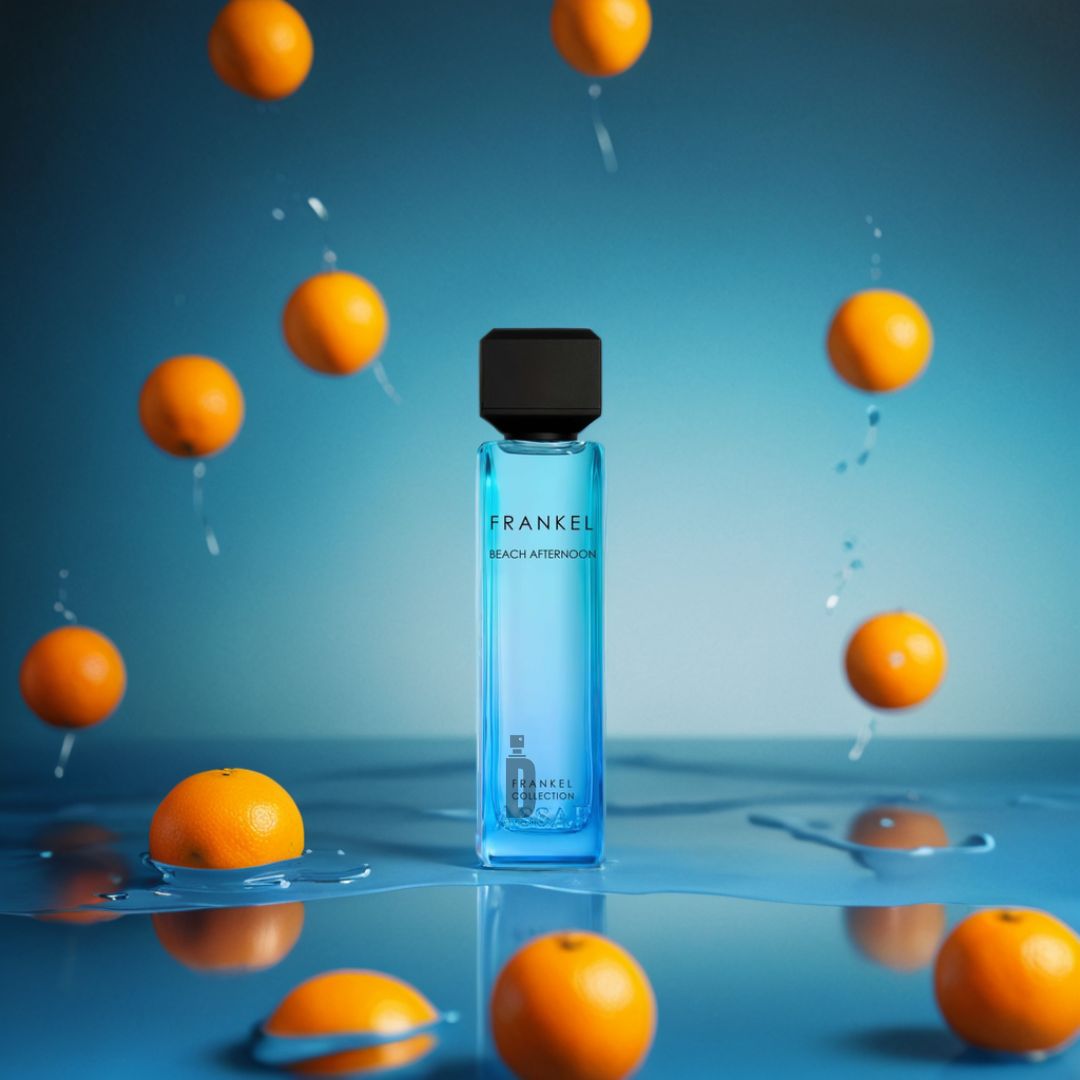 The Frankel Beach Afternoon 200ml EDP by Assaf stands on a glossy blue surface with fresh oranges and water splashes, evoking a vibrant beach-inspired fragrance with sunlit coastal notes.