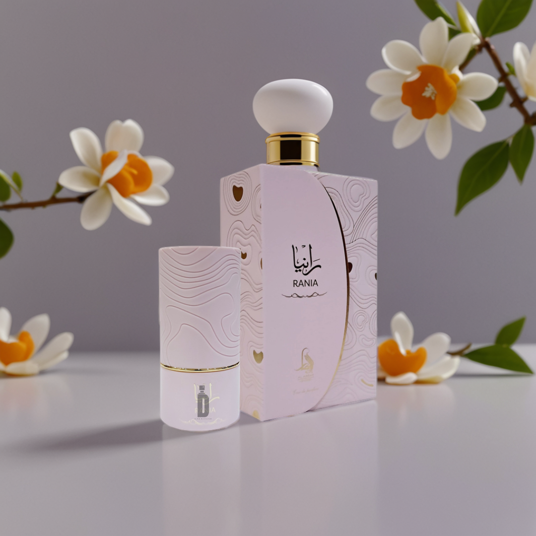 A pink "Rania 100ml EDP - Al Absar" bottle and its matching box, both with Arabic script, are set among white and yellow flowers and orange blossom hints on a light, elegant background.