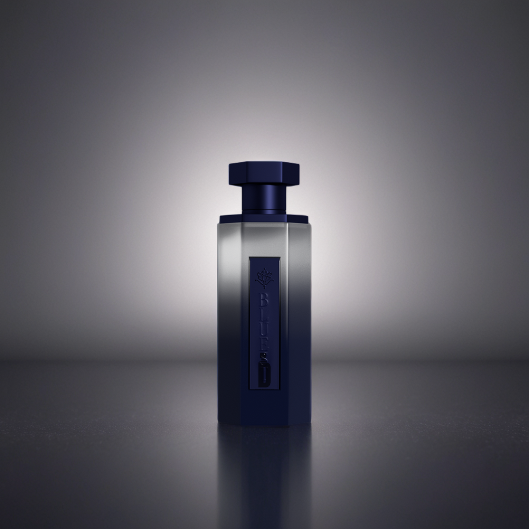The Bluest 200ml EDP by Reef, in a dark blue bottle with a hexagonal cap, stands upright on a reflective surface and glows subtly, evoking the allure of its refined amber scent.