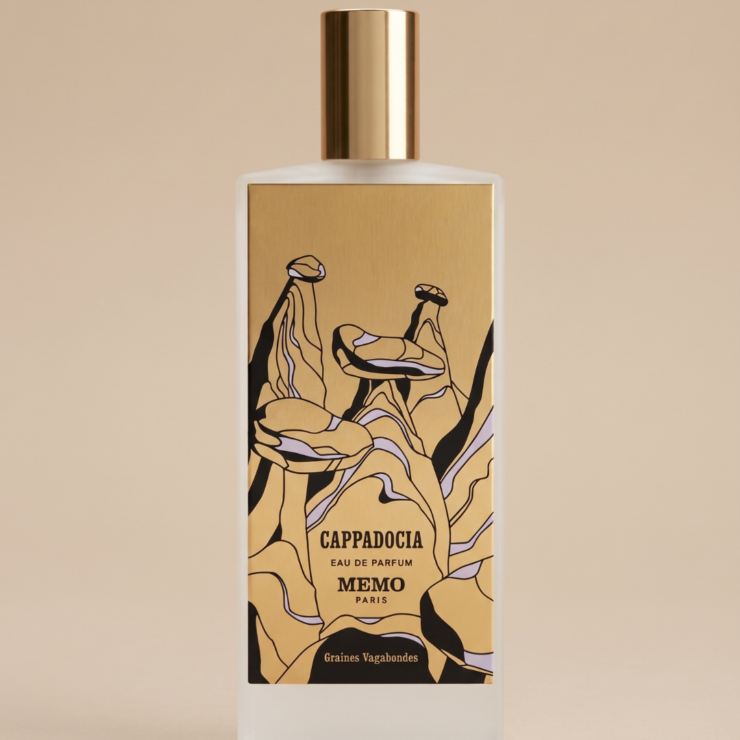 The Cappadocia 75ml EDP by Memo Paris comes in a striking bottle adorned with a gold label, decorated with abstract black-and-white illustrations of Cappadocia’s iconic rock formations and the inscription “Cappadocia Eau de Parfum Memo Paris Graines Vagabondes.” This fragrance captures the spirit of an ancient landscape, brought to life with vibrant notes of exotic saffron.
