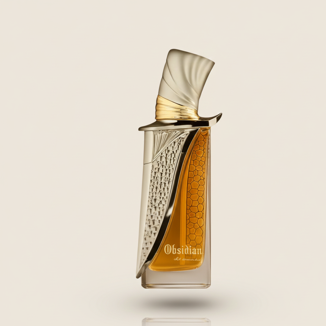 Obsidian 100ml EDP by Fragrance World features a stylish bottle with a gold and silver sculpted cap, honeycomb detail, and amber-hued fragrance, offering an elegant, long-lasting scent experience on French Avenue.