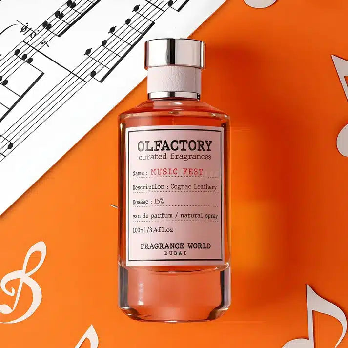 A bottle of Olfactory Music Fest 100ml EDP by Fragrance World is displayed on an orange background decorated with white musical notes. The label describes the scent as "Cognac Leathery with a hint of vetiver," featuring a 15% dosage and containing 100ml/3.4 FL. OZ., crafted by Fragrance World, Dubai.