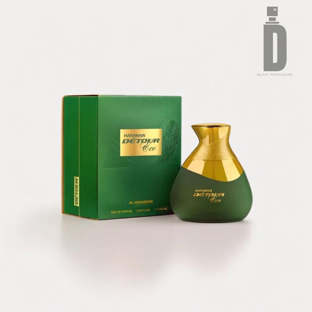 An image of the Al Haramain Detour Eco 100ml EDP perfume box and bottle. This unisex fragrance is presented in a green box with gold accents, displaying the brand name and product name. The bottle mirrors this styling, featuring a green body and a gold cap. The Dune Perfumes logo is visible at the top right.
