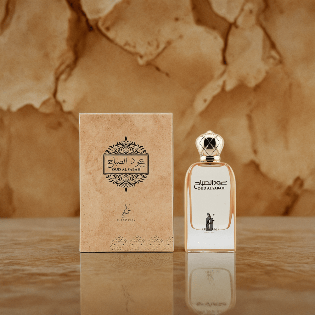 The Oud Al Sabah 100ml EDP by Khadlaj stands beside its ornate box with Arabic script, both set against a textured brown background, evoking the fresh bergamot notes within.