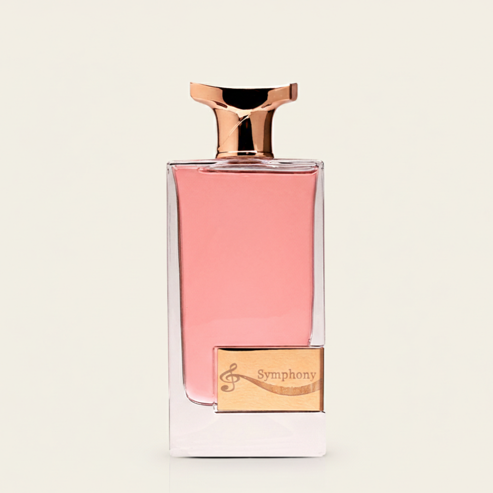 The Symphony 100ml EDP by Aurora Scents features a clear glass bottle with pink liquid, a gold cap, and a gold label adorned with a treble clef and "Symphony," presenting an elegant fragrance from Aurora Scents against a light background.