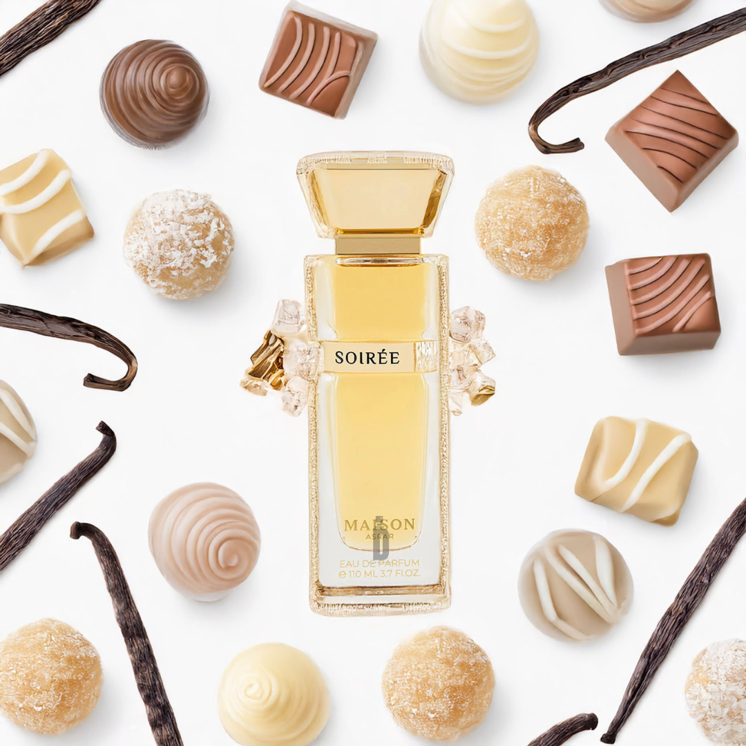 A bottle of Soiree 110ml EDP by Maison Asrar from Gulf Orchid sits surrounded by assorted white, milk, and dark chocolates, truffles, and scattered vanilla pods on a white background.
