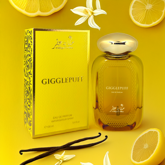 A yellow "Gigglepuff" 100ml EDP by Hekayat Attar sits beside its box. Vanilla pods, white flowers, and Italian lemon slices are artfully arranged on a yellow background, highlighting the gourmand-floral fruity fragrance enriched with coconut cream accord.