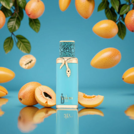 A turquoise bottle of Fragrance World’s Vulcan Feu 100ml EDP - French Avenue, adorned with a gold snake, sits among ripe mangoes and hanging branches—a perfume capturing nature’s exotic allure against a vivid blue backdrop.