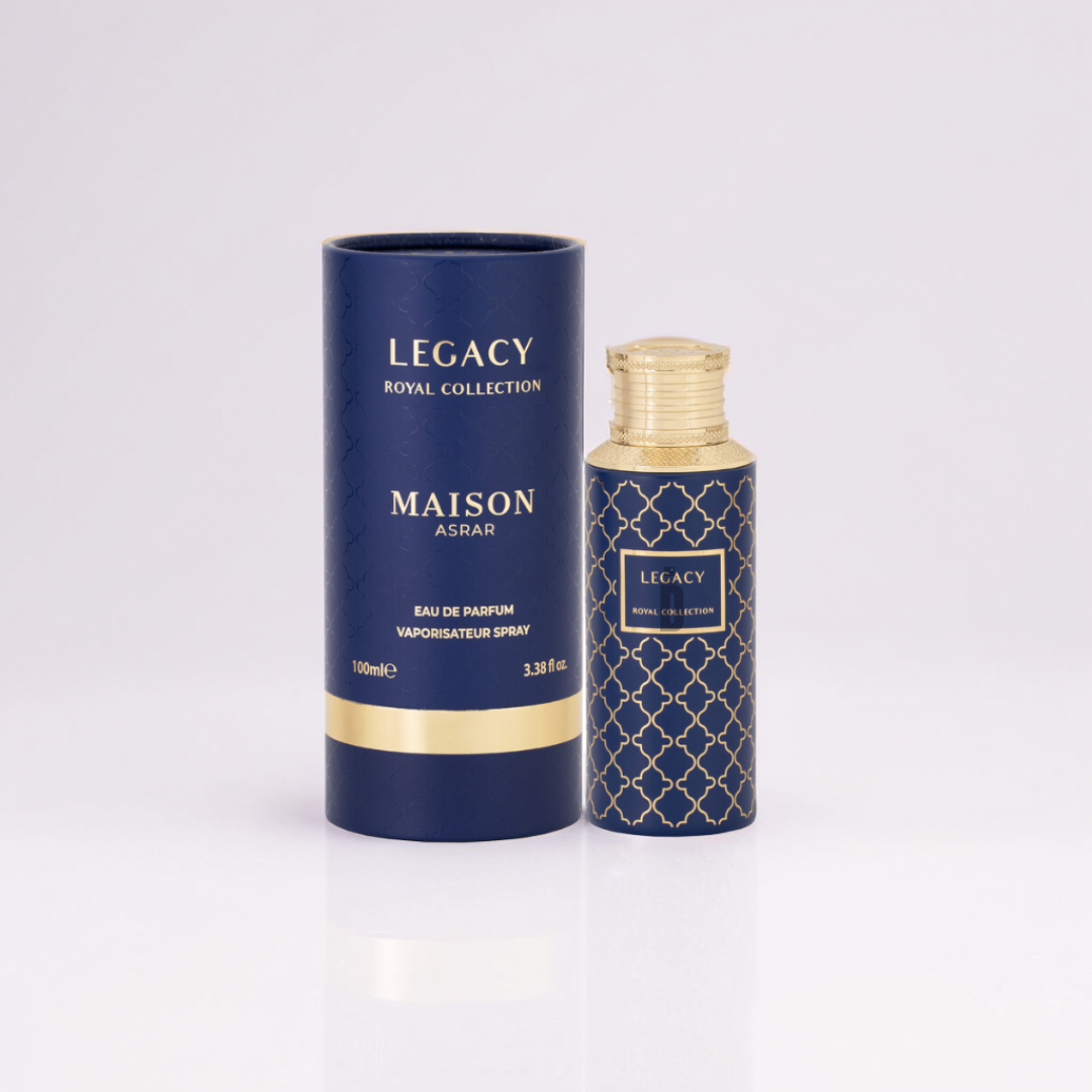 A blue and gold cylindrical perfume bottle labeled "Legacy 100ml EDP - Maison Asrar" by Gulf Orchid sits elegantly beside its matching open box. The lattice design exudes sophistication, while the 100ml eau de parfum spray captures a fragrance of citrus freshness.