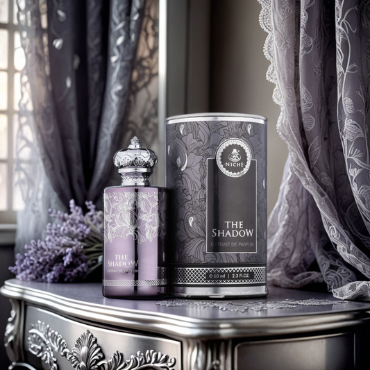 A luxurious setting features a bottle of "The Shadow Extrait 60ml" by Fragrance World on an ornate table, exuding an oud fragrance with floral patterns. A decorative canister and lavender flowers enhance the scene as elegant lace curtains frame sunlight from a window.