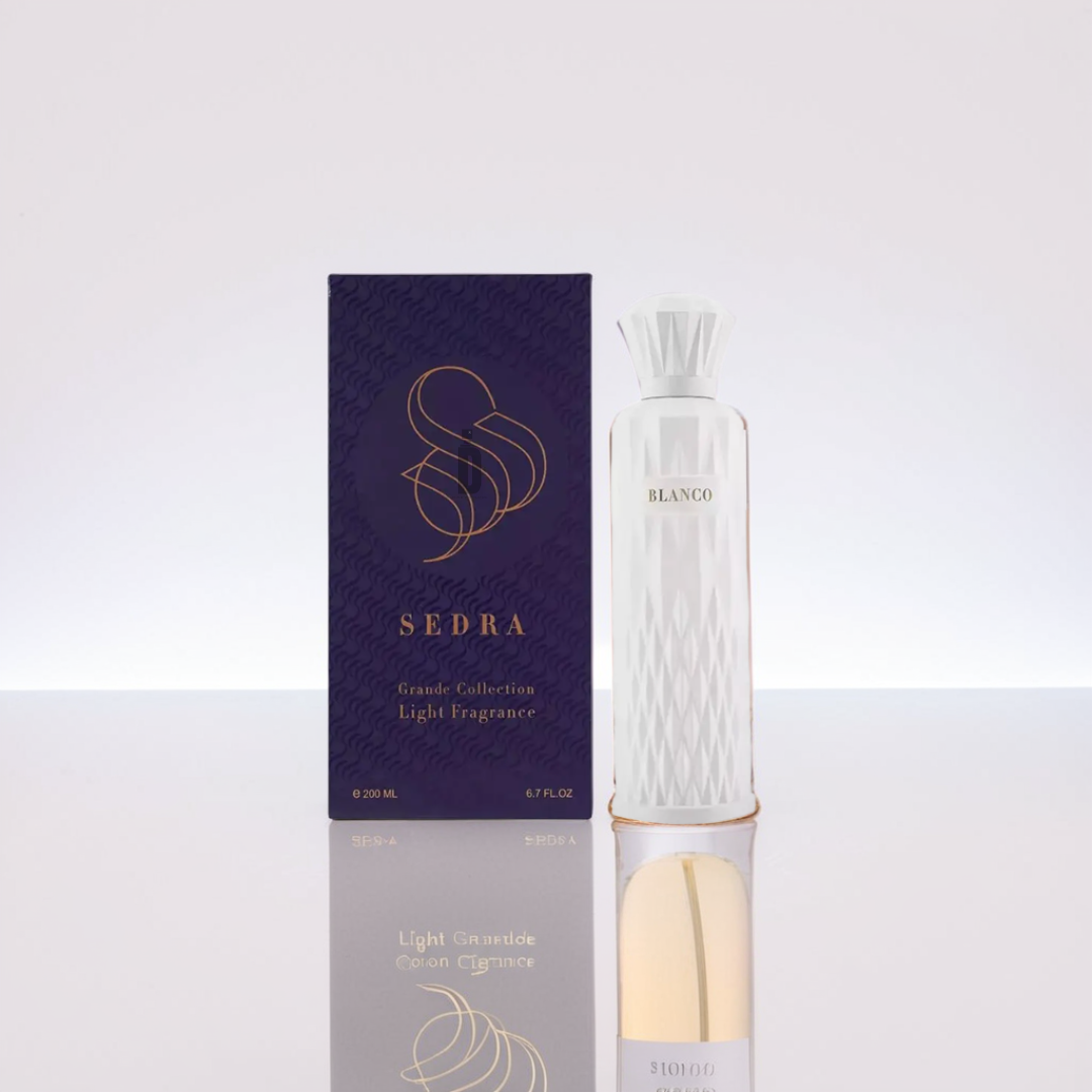 A white "Blanco" perfume bottle (200ml EDP) from Sedra stands beside a dark blue box with gold text: "Sedra, Grande Collection, Light Fragrance." Its fluted cap hints at the exquisite scent within, reflecting on the surface.