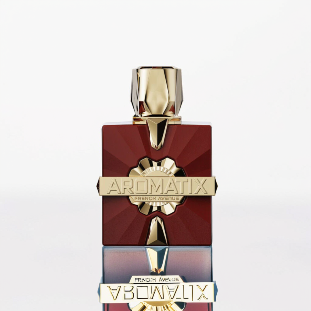 The elegant Carnal Desire 100ml EDP by Fragrance World, a collaboration between French Avenue and Aromatix, is showcased in a bold maroon and gold geometric bottle. This sensual masterpiece stands out against a white background, captivating with its striking reflection.