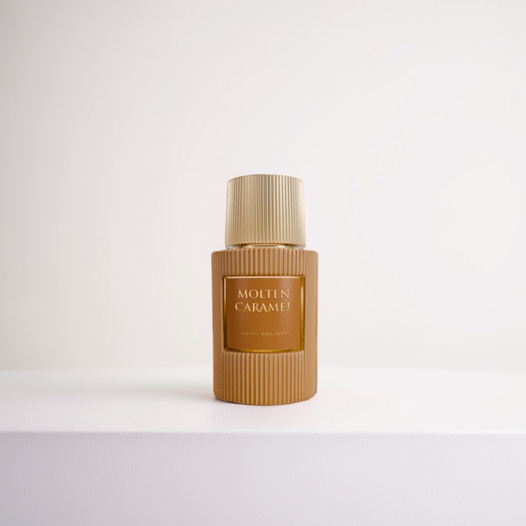A Molten Caramel 100ml EDP from Paris Corner is displayed against a white background, showcasing the gold ribbed-textured bottle and cap that radiate indulgence, for a cohesive, minimalist look.