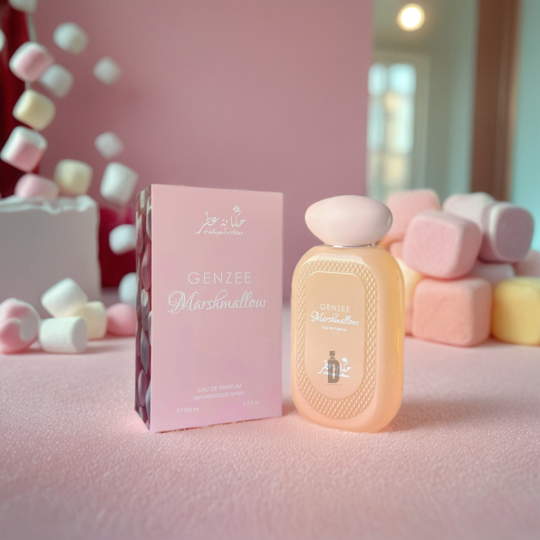The Genzee Marshmallow 100ml EDP by Hekayat Attar sits next to its matching box, surrounded by large colorful marshmallows under soft ambient lighting, creating a dreamy pink marshmallow scene while exuding a sweet fragrance.