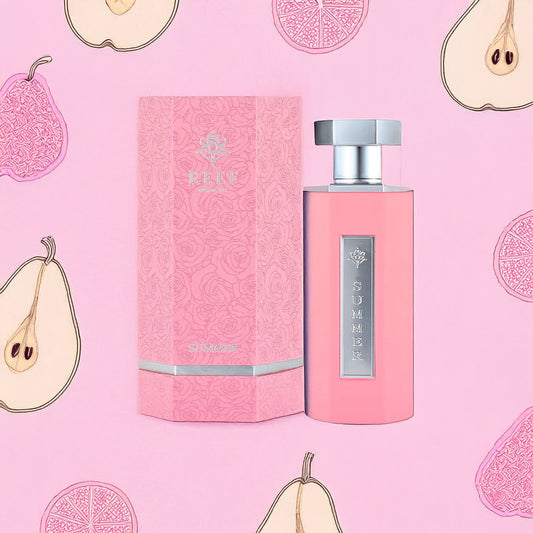 The Summer Pink 100ml EDP by Reef features a pink bottle and matching floral-patterned box set against a pink background with illustrated pears and citrus slices. Silver accents, including a metallic label, enhance its elegance.