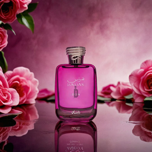 Hawas Diva 100ml EDP by Rasasi, a luxury women’s fragrance, comes in a pink bottle with silver cap and bilingual label. It is showcased amid pink roses on a reflective surface against a pink and purple gradient backdrop.
