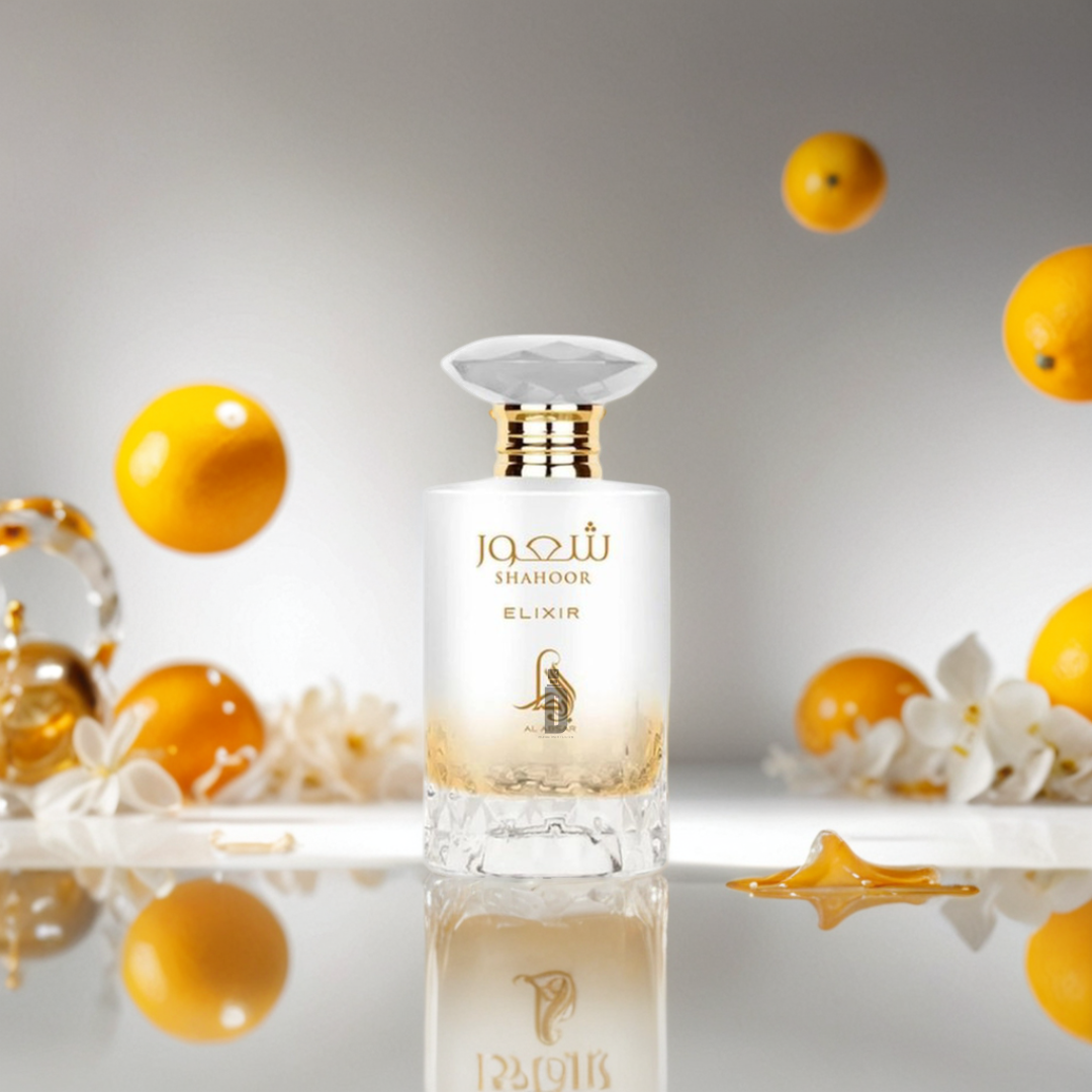 The Shahoor Elixir 100ml EDP by Al Absar stands among white flowers, honey drops, and yellow citrus fruits, reflecting its long-lasting fragrance against a soft background.
