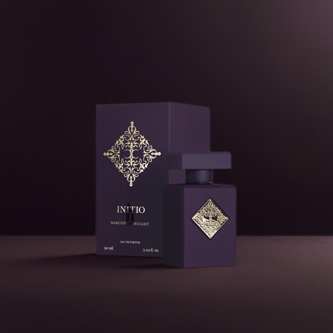 The Initio Narcotic Delight 90ml EDP features a dark purple bottle and box with a gold emblem, set against a deep purple background, reflecting the sensual allure and narcotic charm of this signature fragrance by Initio.