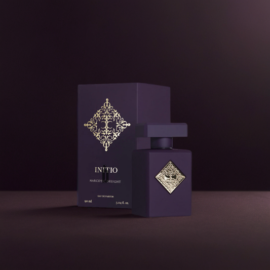 The Initio Narcotic Delight 90ml EDP features a dark purple bottle and box with a gold emblem, set against a deep purple background, reflecting the sensual allure and narcotic charm of this signature fragrance by Initio.
