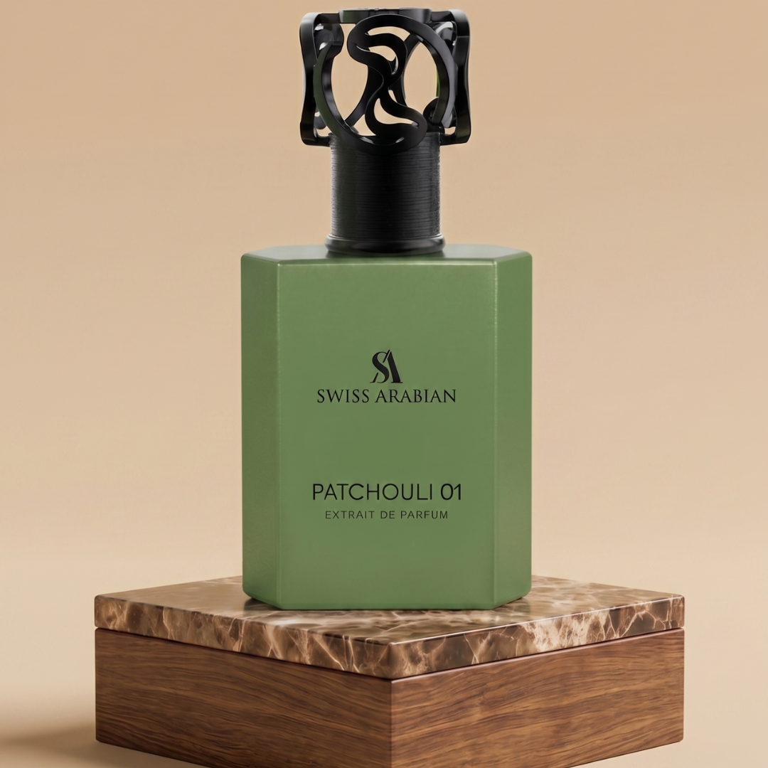 A green rectangular bottle of Swiss Arabian Patchouli 01 50ml Extrait De Parfum with a black cap sits on a brown marble-textured box against a beige background, highlighting the earthy elegance of this signature scent.