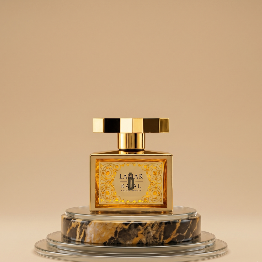The Lamar 100ml EDP by Kajal, a gold bottle with ornate detailing and a square cap, is displayed on a round black and gold marble base against a beige background. This Kajal perfume is known for its fruity floral scent.
