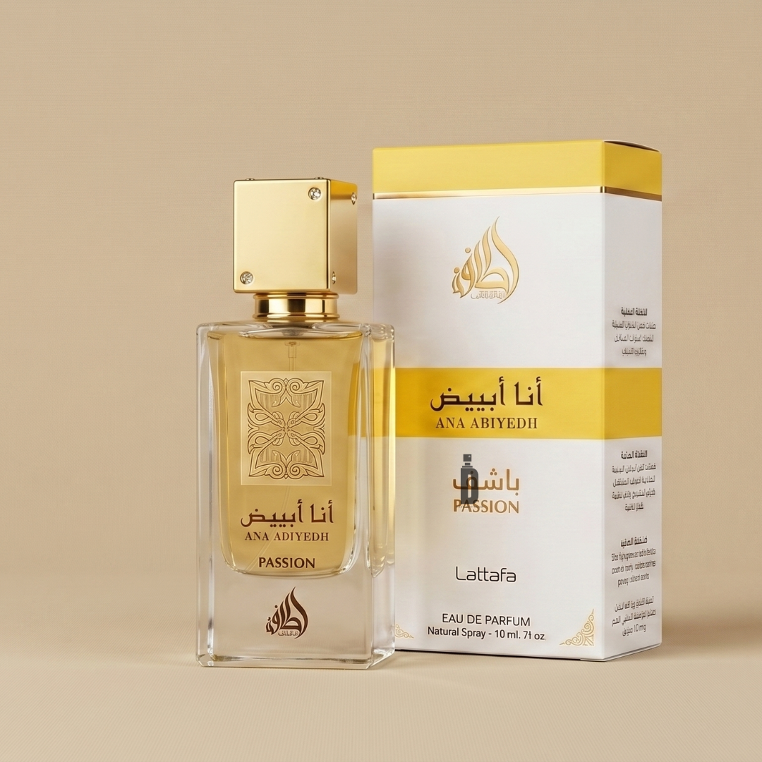 A bottle of Ana Abiyedh Passion 60ml EDP by Lattafa stands beside its white and gold box, both featuring Arabic and English text, on a beige background.