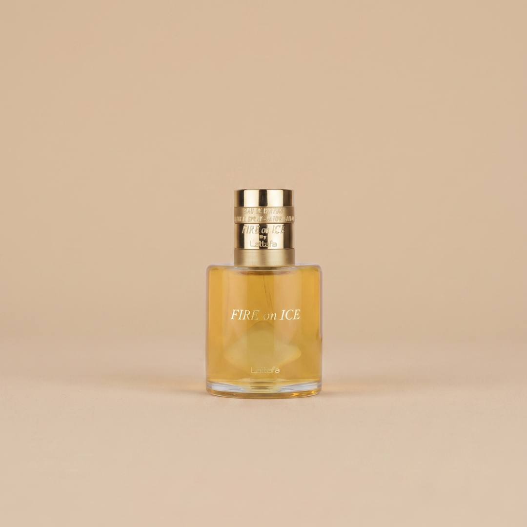 A clear glass perfume bottle with a gold cap labeled "Fire On Ice 100ml EDP - Lattafa" by Lattafa, a bold fragrance, is set against a plain beige background.