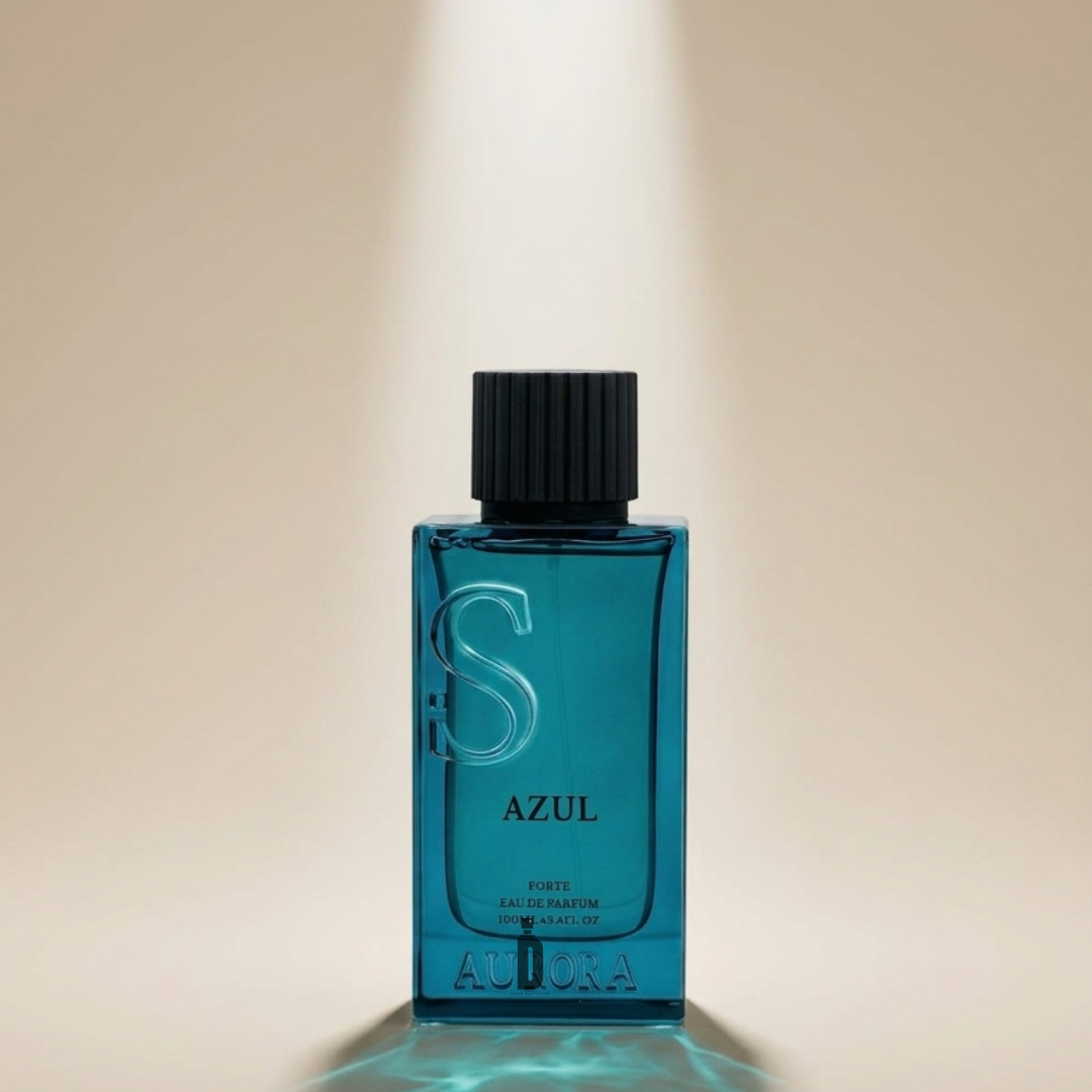 A blue glass bottle of Azul 100ml EDP by Aurora Scents with a black cap stands upright under a beam of light against a beige background, the brand's name visible at the base, evoking its fresh aromatic scent.