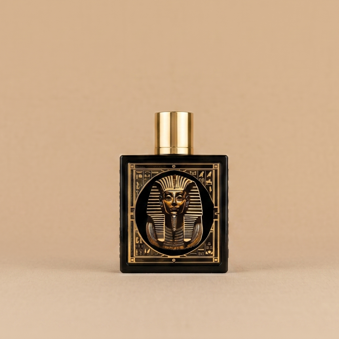 Rayhaan’s Pharaoh 100ml EDP comes in a black bottle with a gold cap, adorned with an ornate gold ancient Egyptian pharaoh’s head and hieroglyphics, hinting at its bold scent, set against a plain beige background.