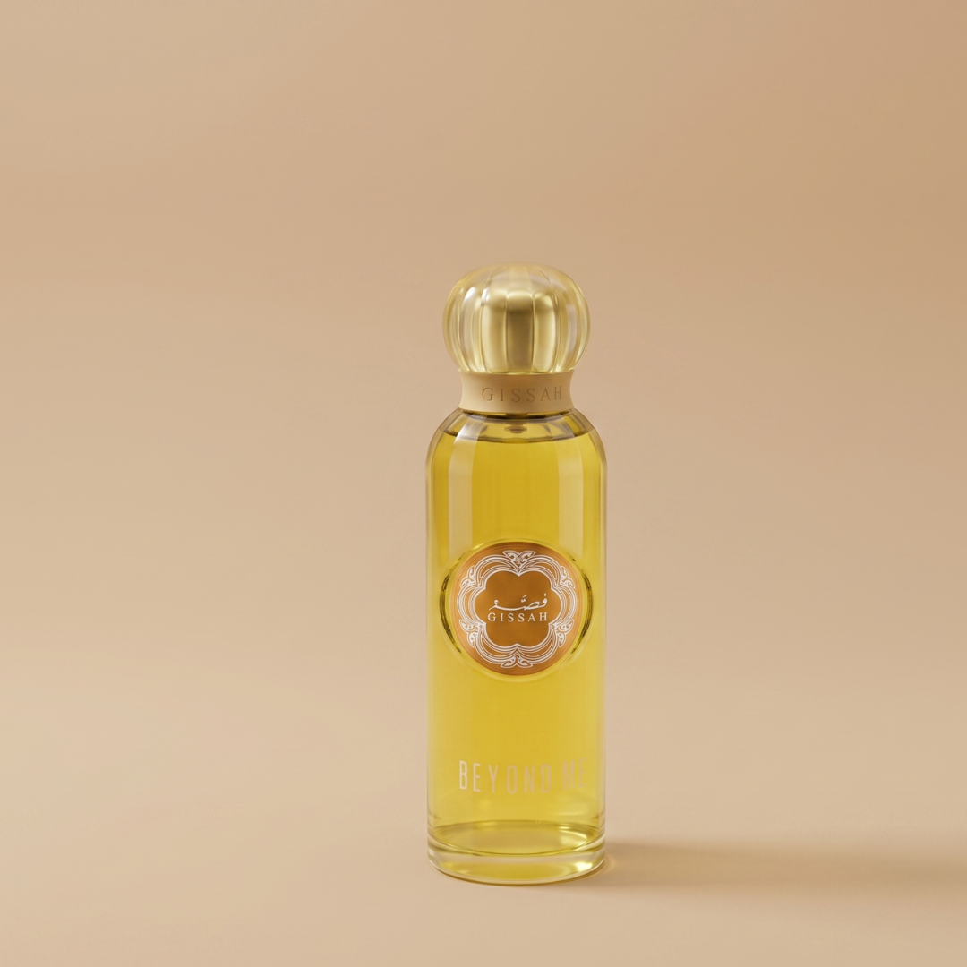 A gold-capped Gissah perfume bottle labeled "Beyond Me 100ml EDP" stands upright on a beige background, filled with yellow liquid and featuring a decorative front label, promising a long-lasting scent.