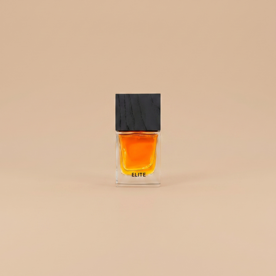A square glass perfume bottle labeled “Elite 100ml EDP - Aurora Scents,” filled with amber liquid and topped with a black rectangular cap, exudes a chic aroma against a plain beige background. This patchouli fragrance from Aurora Scents promises a sophisticated scent experience.