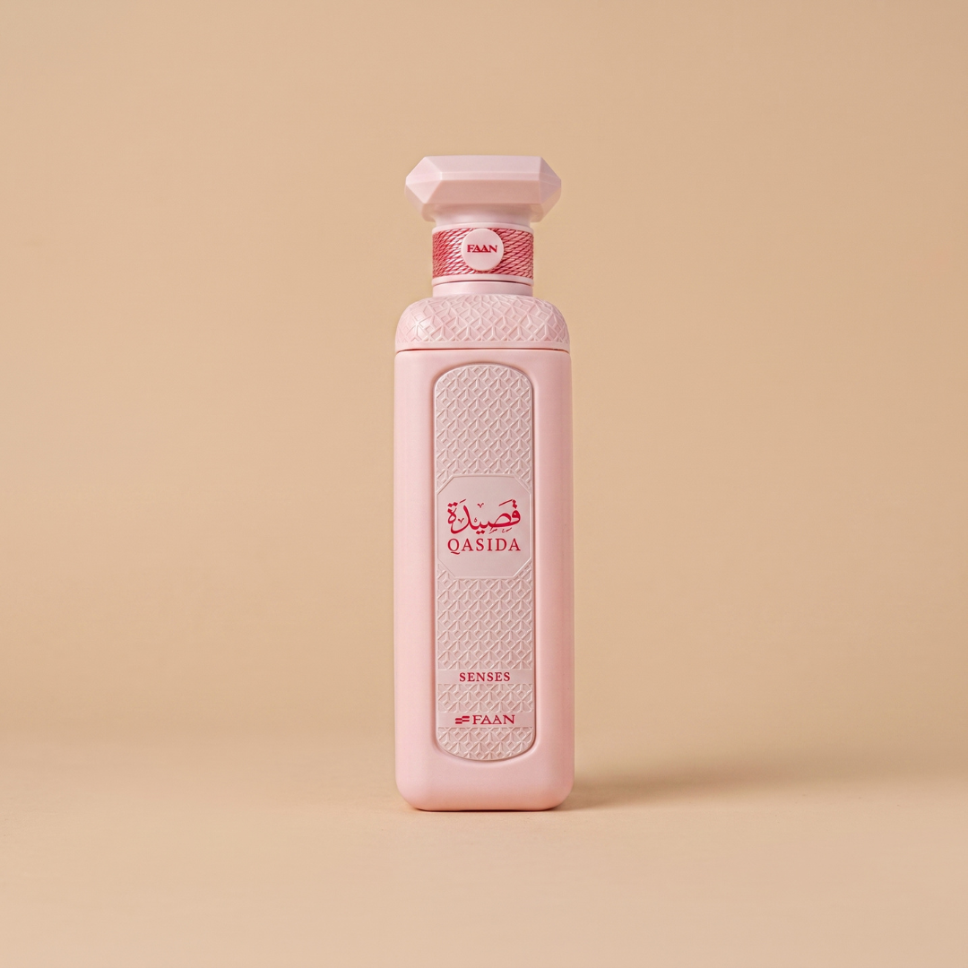 A tall, pink bottle of Qasida Senses 200ml EDP by Faan Perfumes stands upright on a beige background, featuring a textured white panel and “Qasida Senses” displayed in Arabic and English, perfectly reflecting the enchanting allure of this fragrance inspired by notes of bourbon vanilla.