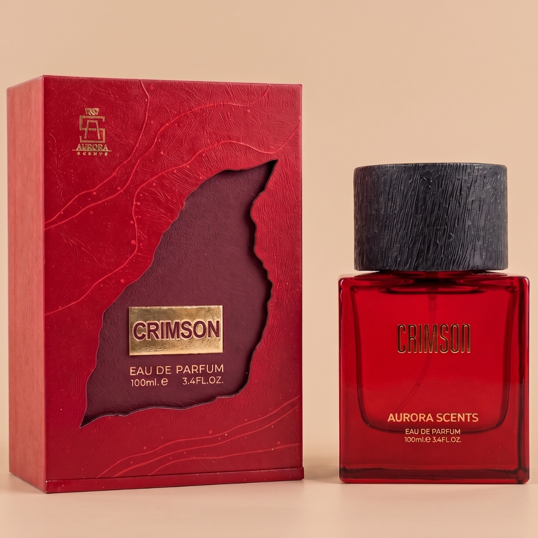 Aurora Scents' Crimson 100ml EDP, a warm gourmand perfume with vanilla caramel notes, comes in a red bottle and matching box with gold text and textured design. "Eau de Parfum" appears on the packaging.