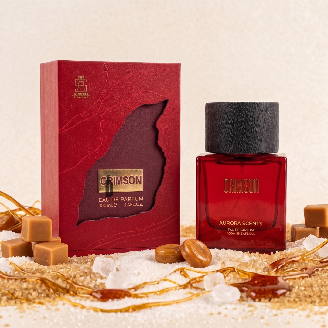 The Crimson 100ml EDP by Aurora Scents is shown with its red bottle and box, surrounded by caramel, sugar, vanilla pods, and spices—suggesting a warm vanilla caramel gourmand fragrance.