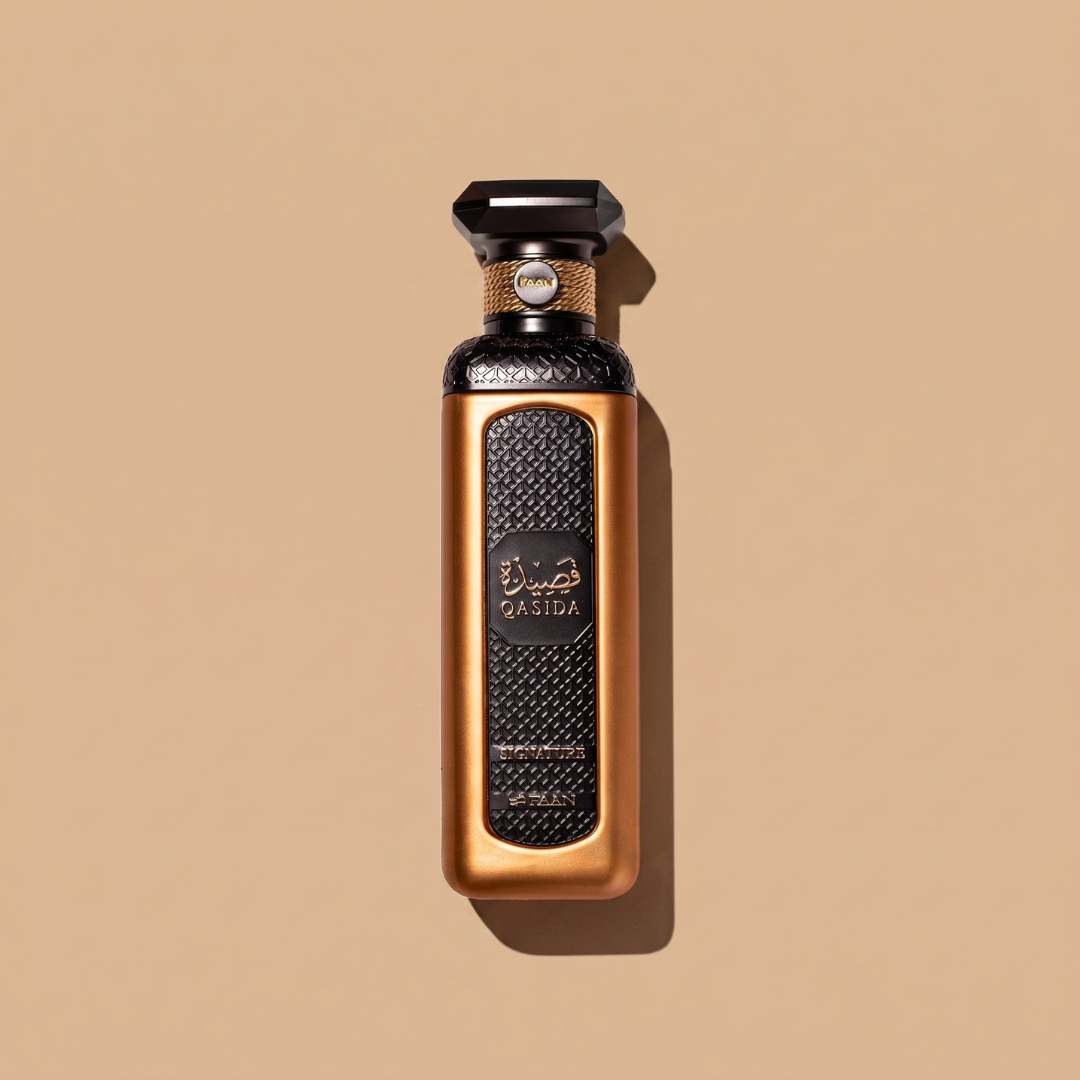 A luxurious 200ml Qasida Signature Eau de Parfum bottle by Faan Perfumes, featuring a gold and black textured design with “Qasida Signature” in English and Arabic on the label, set against a plain beige background.