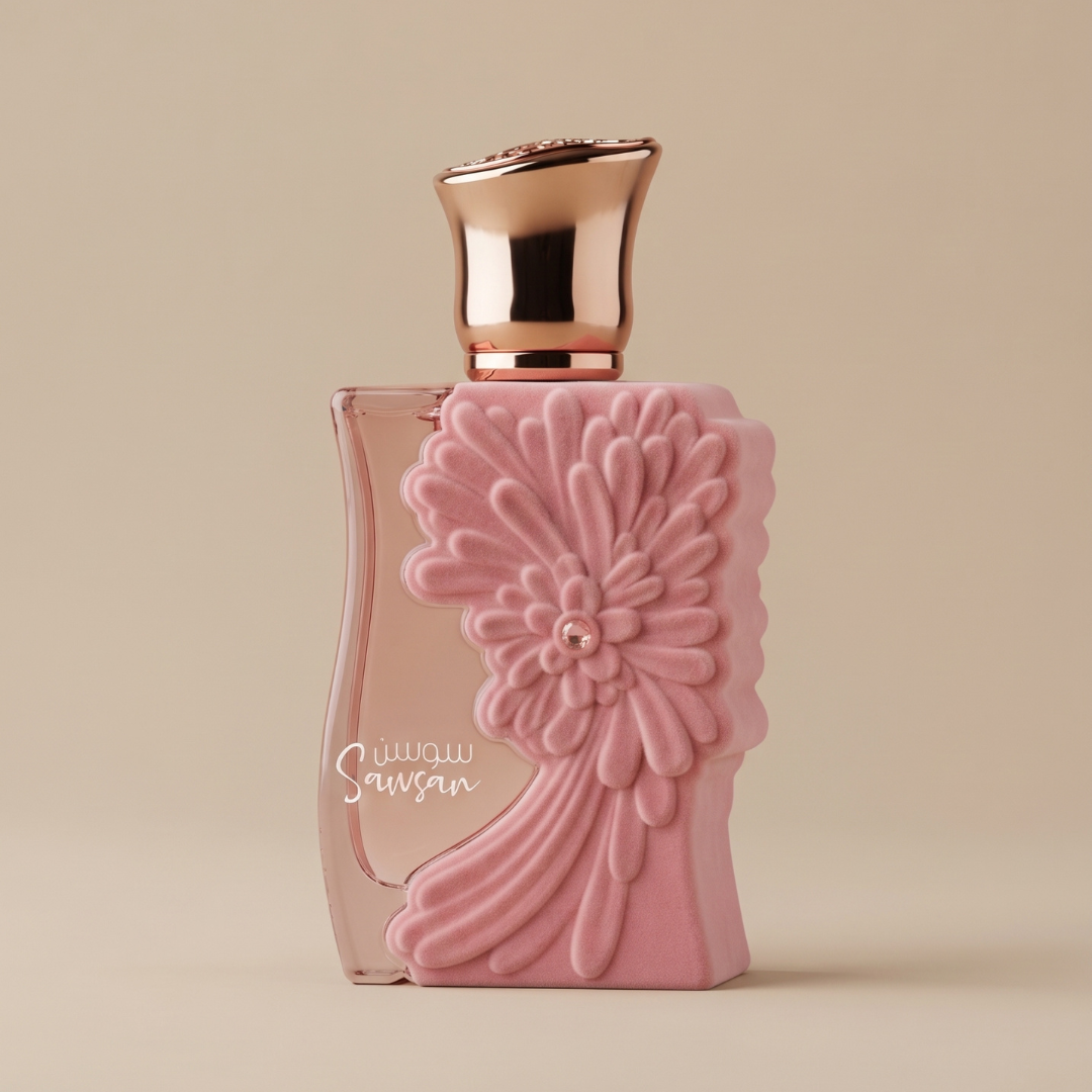 A pink perfume bottle with an ornate flower design and a metallic cap is displayed against a plain beige background. Arabic script on the bottle identifies it as Sawsan 100ml EDP by Ard Al Zaafaran, a tropical floral fragrance that exudes elegance and allure.