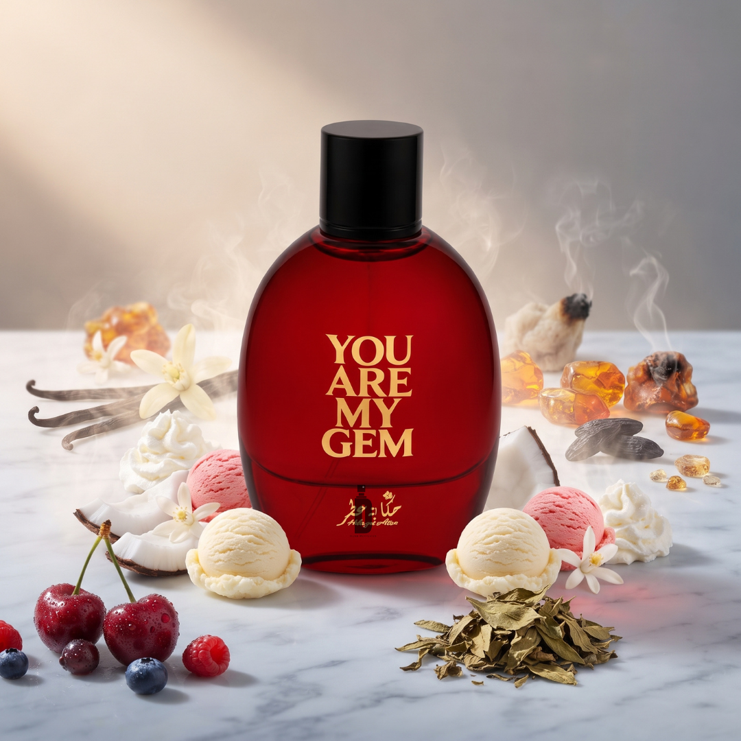 A bottle of You Are My Gem 100ml EDP by Hekayat Attar, its vibrant red design catching the eye atop a marble surface, is surrounded by cherries, vanilla bean pods, creamy ice cream scoops, dollops of whipped cream, amber stones, shimmering gold flakes, and smoky incense. This tempting display perfectly embodies the fruity gourmand character and irresistible cherry notes of this Hekayat Attar fragrance.
