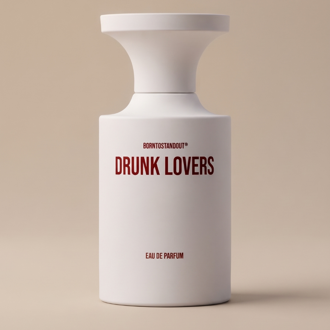 A minimalist white 50ml Eau De Parfum bottle labeled “Drunk Lovers” in striking red text, with “EAU DE PARFUM” and the BornToStandOut brand name printed on the front, stands out against a neutral beige background. This Drunk Lovers 50ml EDP by BornToStandOut features a captivating, long-lasting fragrance that makes it an unforgettable statement piece.