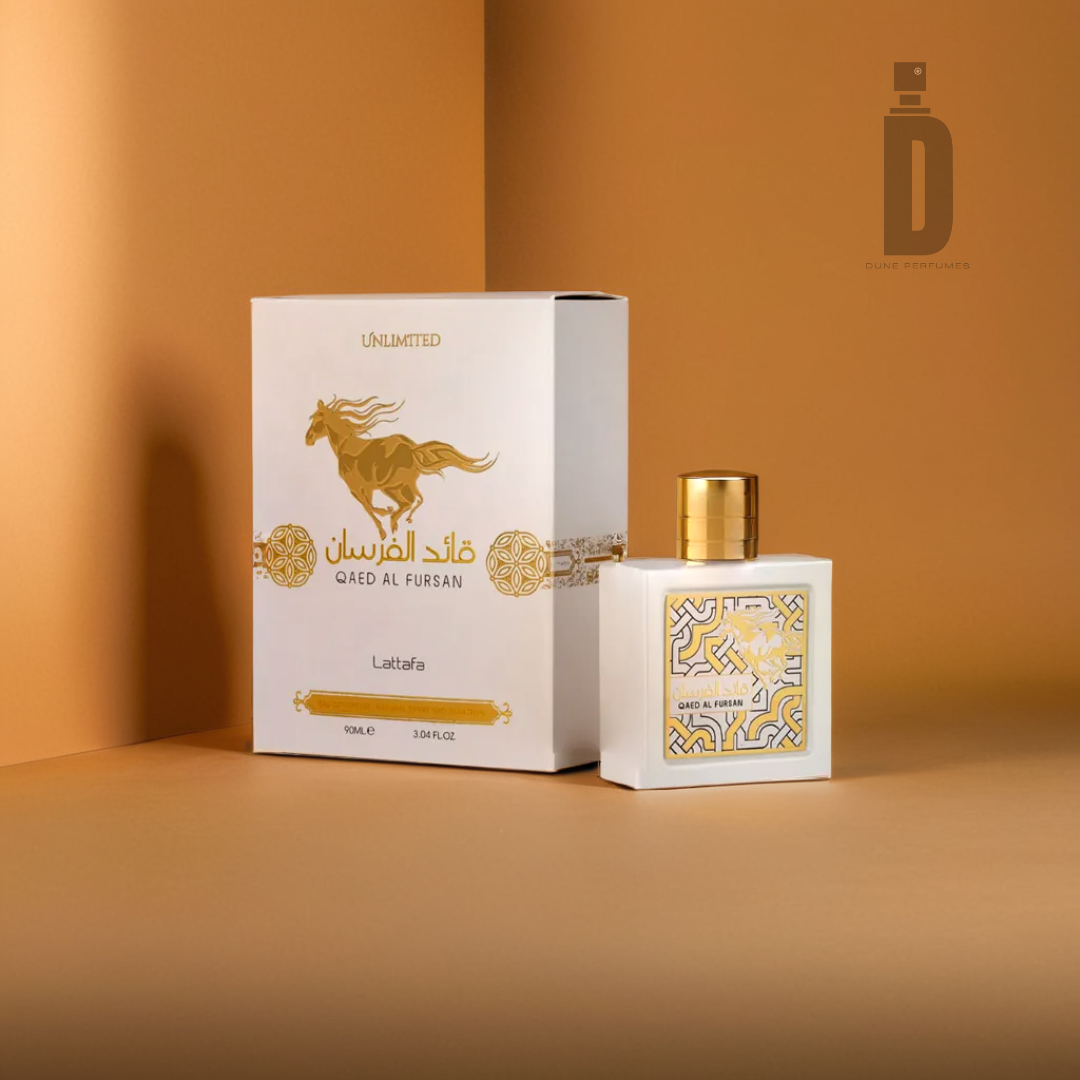 The image displays the Qaed Al Fursan Unlimited 90ml EDP by Lattafa and its packaging. The box is predominantly white with gold accents, featuring a design that incorporates a horse motif. The perfume bottle mirrors this elegance, with a white exterior embellished by a gold geometric pattern and cap, all set against an inviting warm brown backdrop.