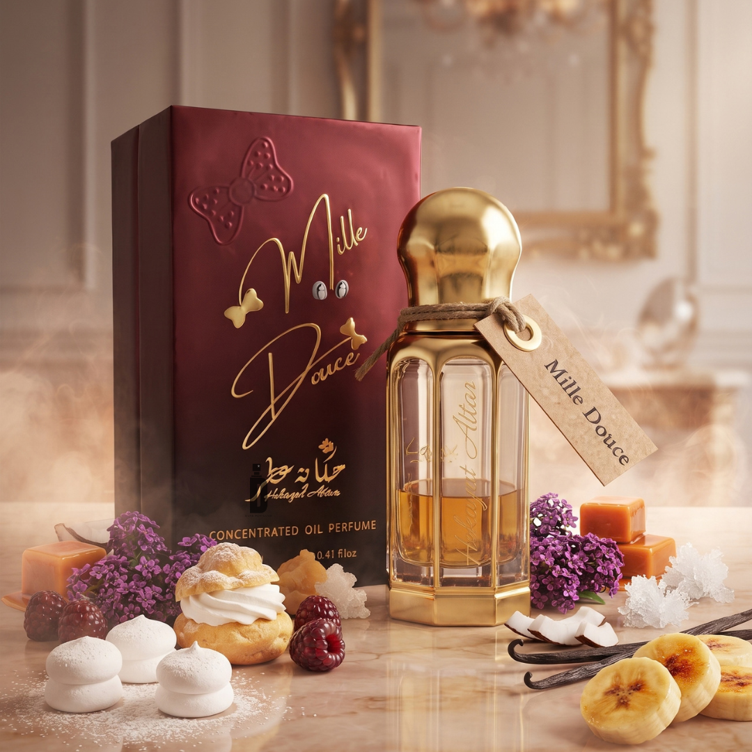 A Mille Douce 100ml EDP - Hekayat Attar perfume bottle with a gold cap sits next to its dark red box, surrounded by scattered raspberries, cream puffs, lilac flowers, caramel cubes, vanilla beans, and banana slices in a creamy gourmand arrangement.