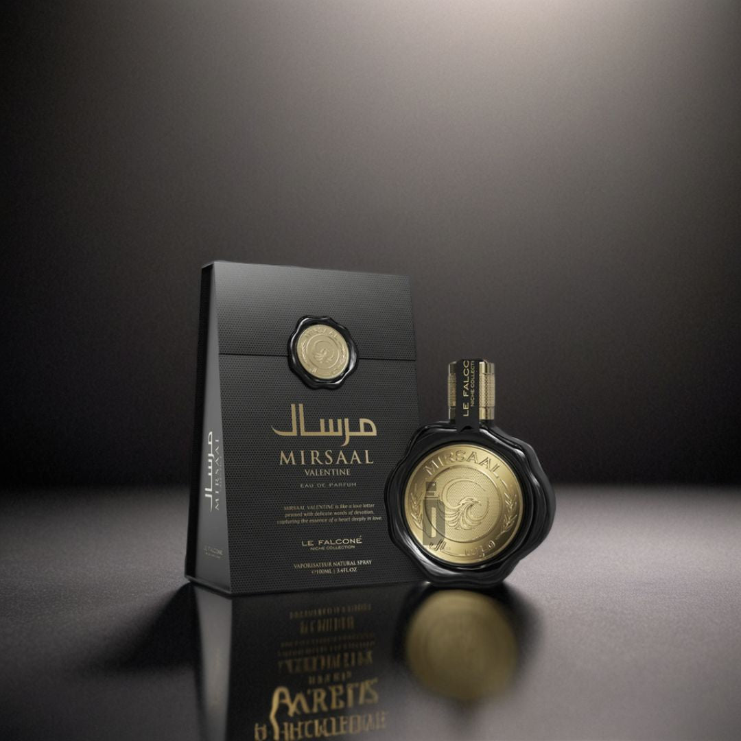 The gold and black Mirsaal Valentine 100ml EDP by Le Falconé stands beside its textured box under dramatic lighting—an elegant, romantic fragrance ideal for special occasions.