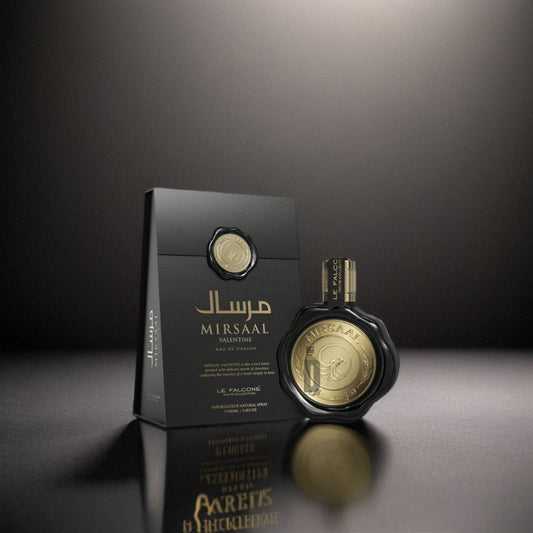 The gold and black Mirsaal Valentine 100ml EDP by Le Falconé stands beside its textured box under dramatic lighting—an elegant, romantic fragrance ideal for special occasions.