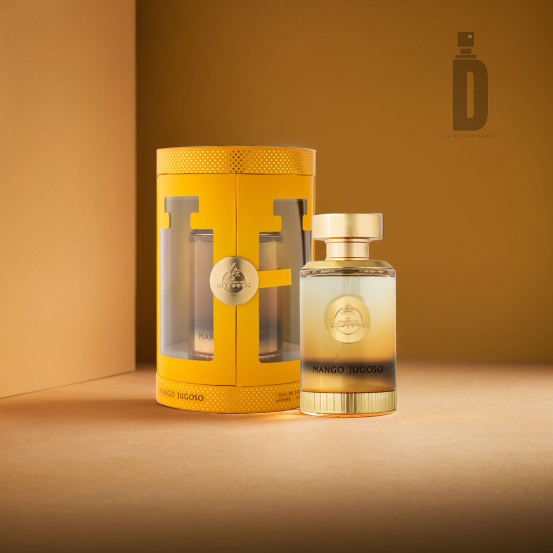 A 100ml EDP bottle named "Mango Jugoso" by Paris Corner is displayed beside its cylindrical yellow packaging in a warmly lit setting, with the brand logo prominently visible on both the bottle and the box.