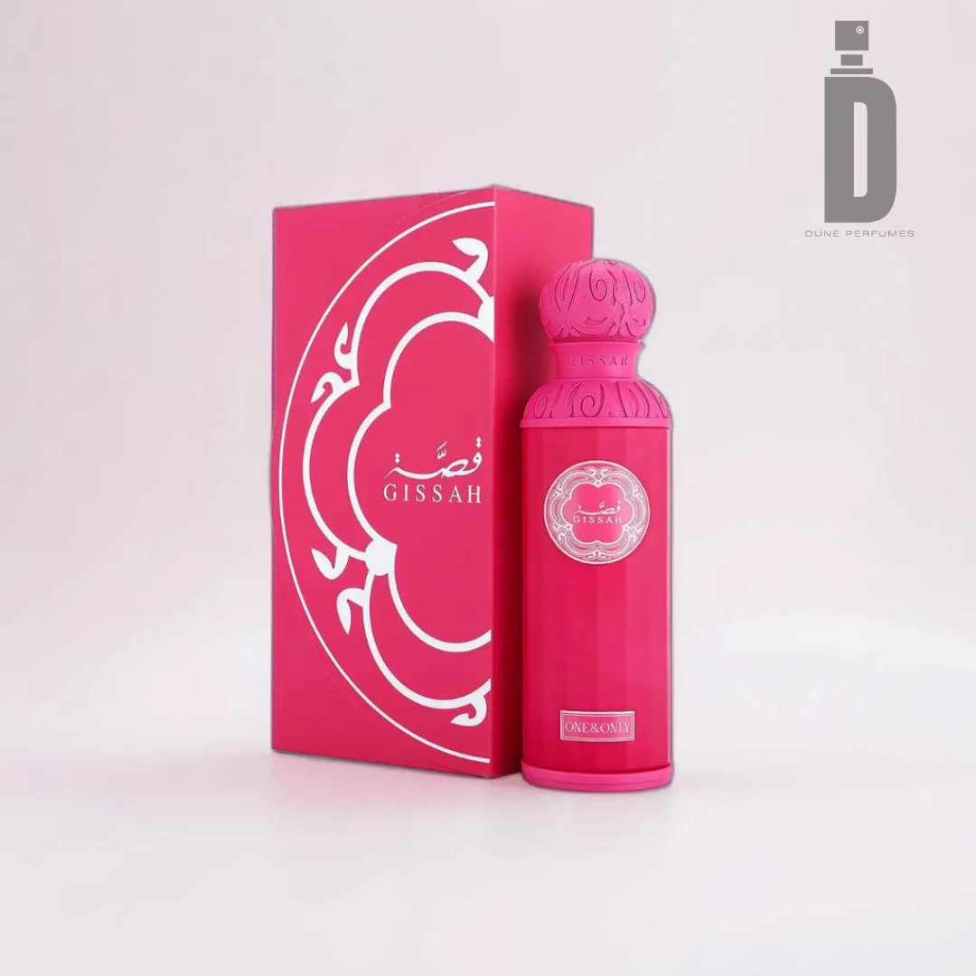 A pink perfume bottle labeled "One & Only 200ml EDP - Gissah" sits beside its matching pink box adorned with white ornate designs. The words "Dune Perfumes" and its logo grace the top right corner, while the light neutral backdrop highlights the floral fruity fragrance, leaving a lasting impression of sophistication.