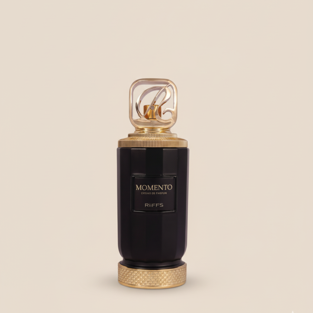 The Momento Riiffs 100ml EDP by Riiffs features a black bottle with gold accents and a decorative cap, displayed against a beige background, capturing the elegance and luxury of this fragrance.