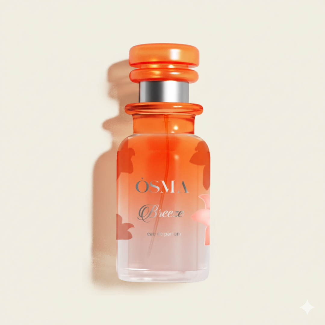 The Osma Breeze 150ml EDP features an elegant design with a vibrant orange cap and gradient orange-to-clear glass, casting a soft shadow on light beige—ideal for fans of sweet, airy fragrances.