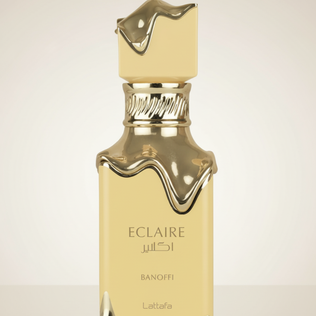 The Lattafa Eclaire Banoffi 100ml EDP features a gold bottle with a melted gold cap and shoulders, set against a simple backdrop—ideal for fans of gourmand fragrances.