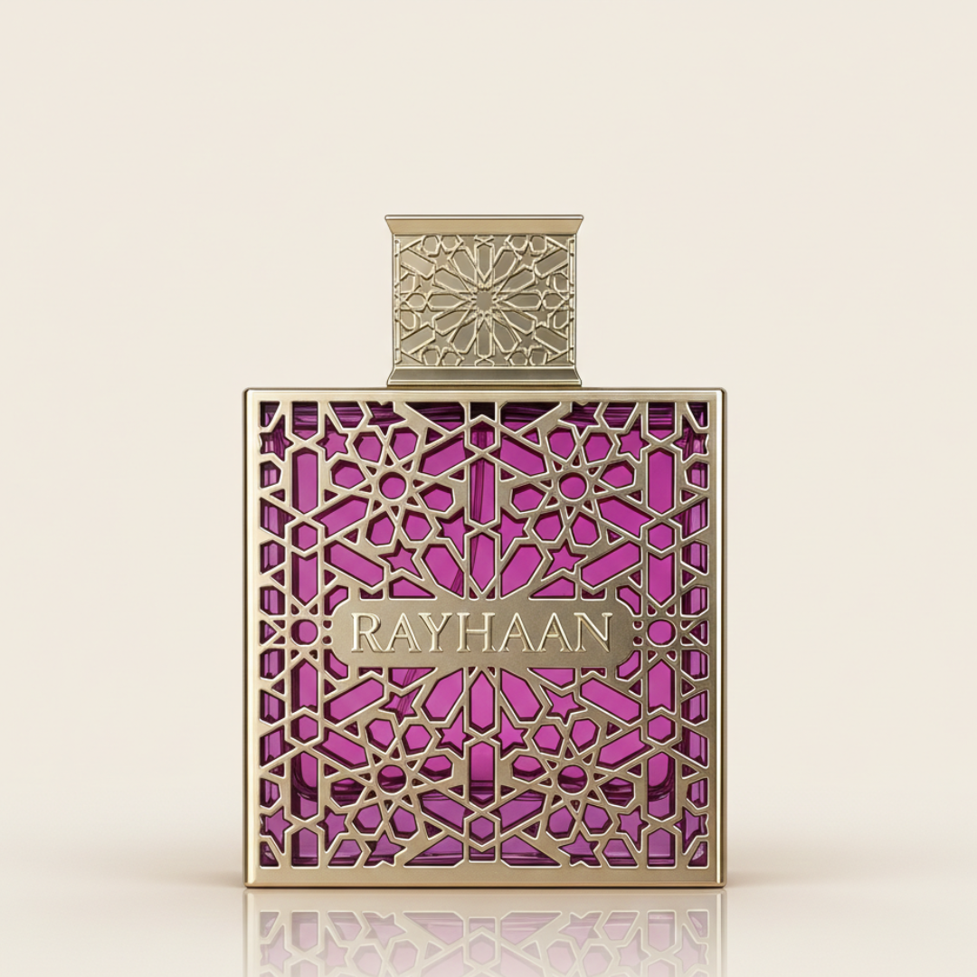 The Rayhaan Kiss 100ml EDP bottle showcases gold geometric patterns on purple glass with a matching ornate cap, reflecting its creamy allure, set against a light background.