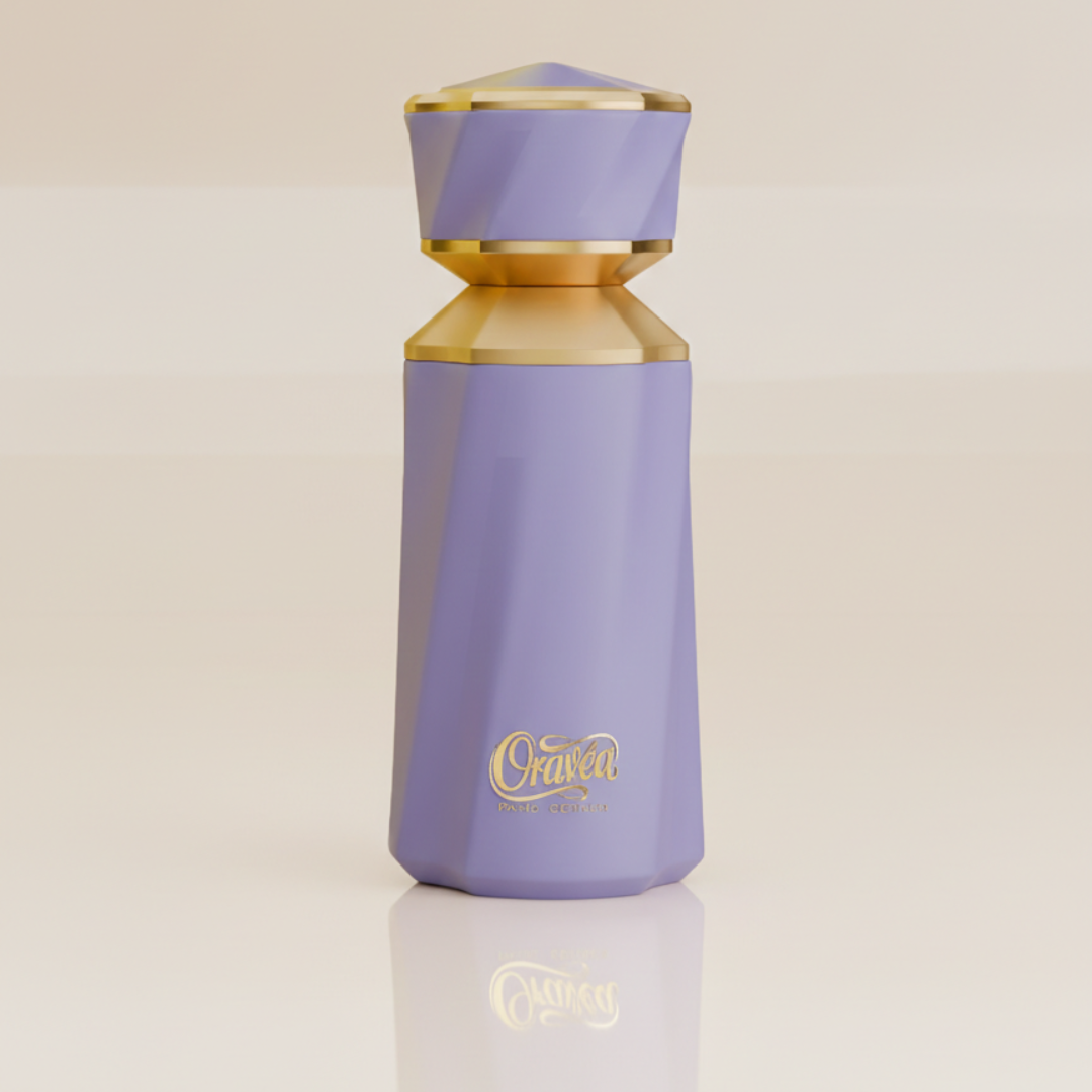 The Oravéa 100ml EDP by Paris Corner features a tall, faceted lavender bottle with gold accents and a matching cap. “Oravéa” is elegantly labeled, making it ideal for lovers of long-lasting perfume. Displayed on a glossy, light surface.
